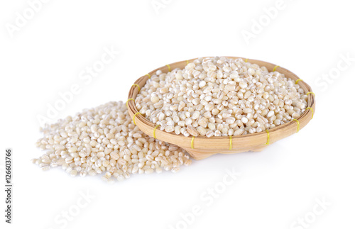 uncooked barley grain in bamboo basket with white background