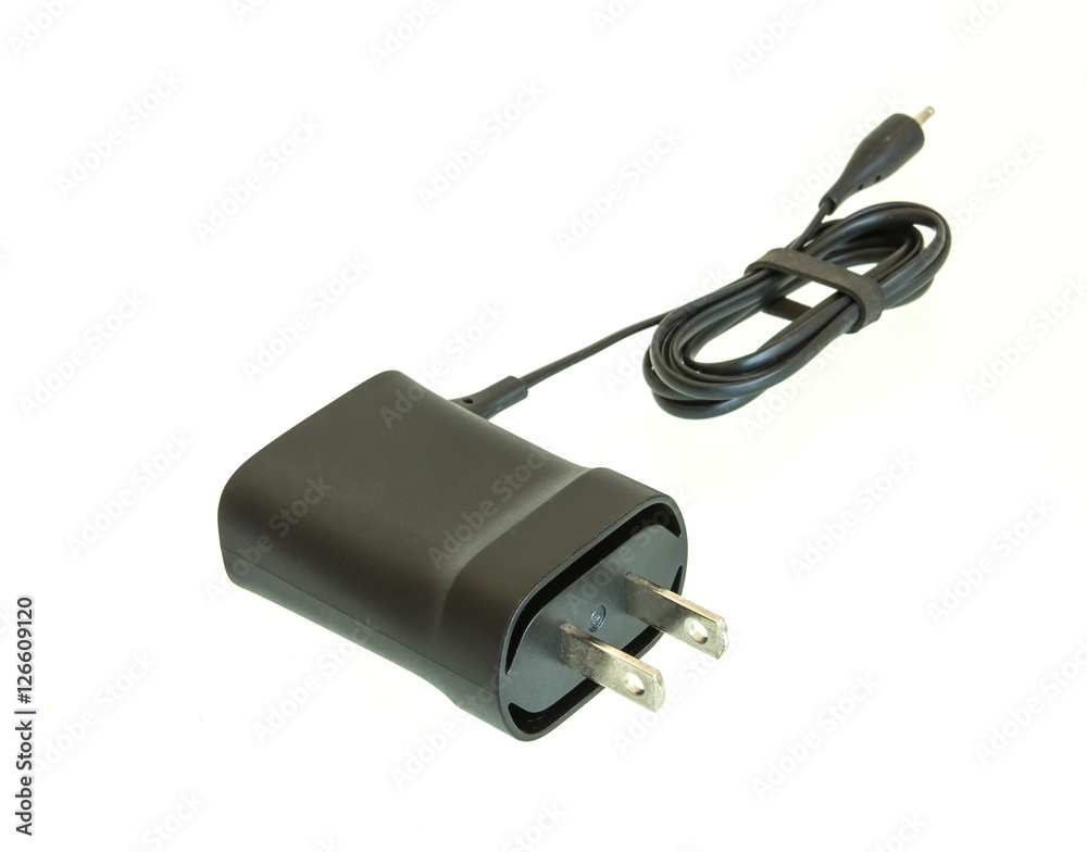 Small charging adapter for device shot on white isolated. Small charging adapter for device shot on white isolated.