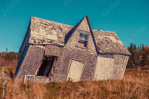 crooked leaning old house with vintage filter