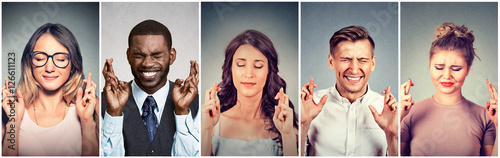 Group of multiethnic young people hopeful crossing their fingers hoping