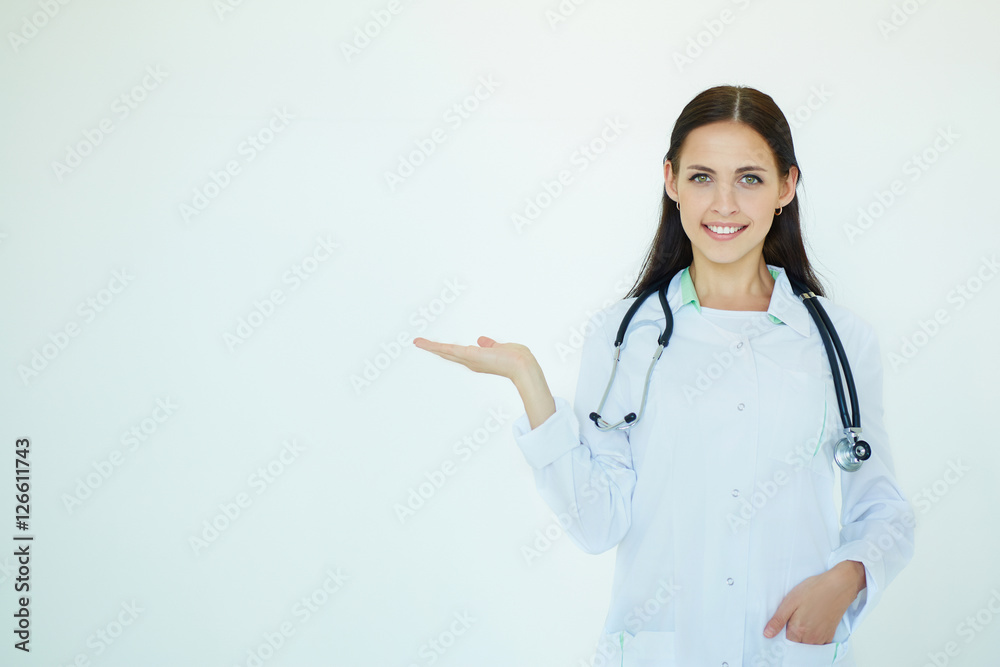 Young female medical doctor presenting and showing copy space for product or text. Caucasian female medical professional isolated. Advertisment concept. Young female medical doctor presenting and showing copy space for product or text. Caucasian female medical professional isolated. Advertisment concept.