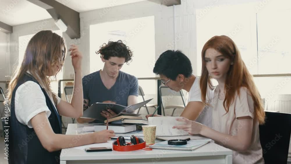 Concentrated business people working at the table in office Concentrated business people working at the table in office