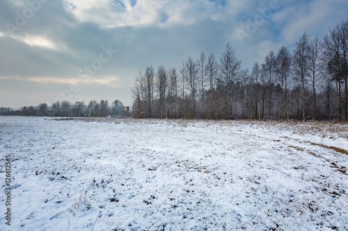 Winter landscape with raised hide and snow covered countryside