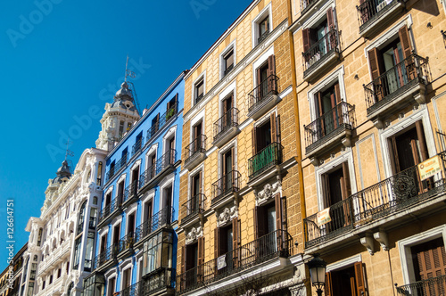 Mediterranean architecture in Spain. Old apartment buildings in famous Calle Mayor in Madrid. © andrii_lutsyk