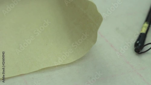 Unrolls the Scroll From Vintage Paper.
