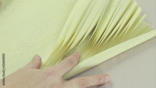 Vintage Paper. Girl Unrolls the Scroll of Paper For Calligraphy.