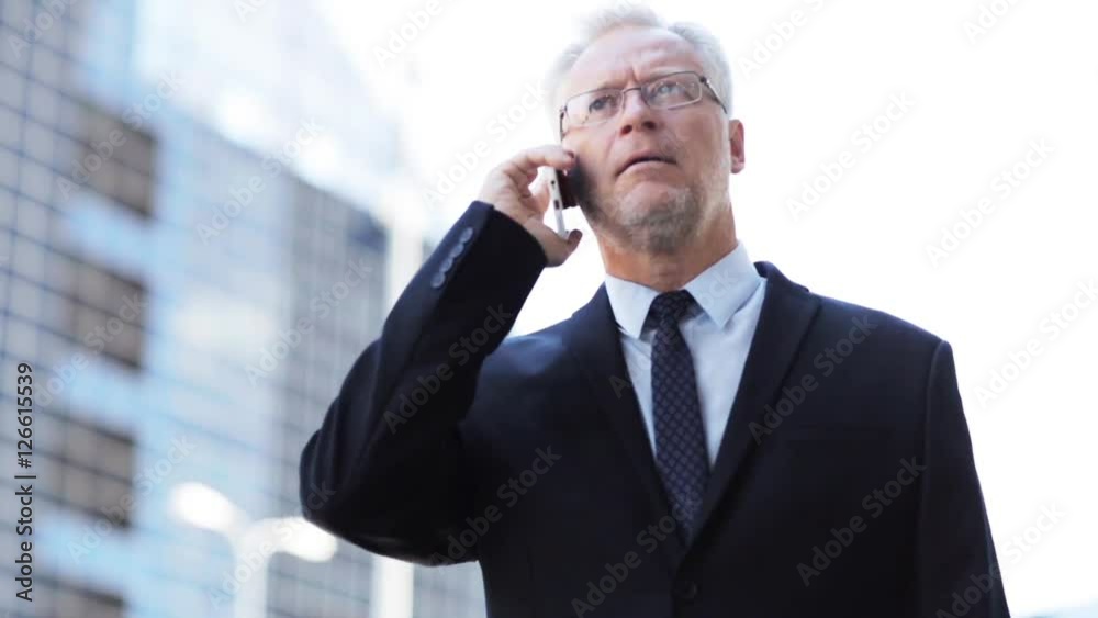 senior businessman calling on smartphone in city senior businessman calling on smartphone in city