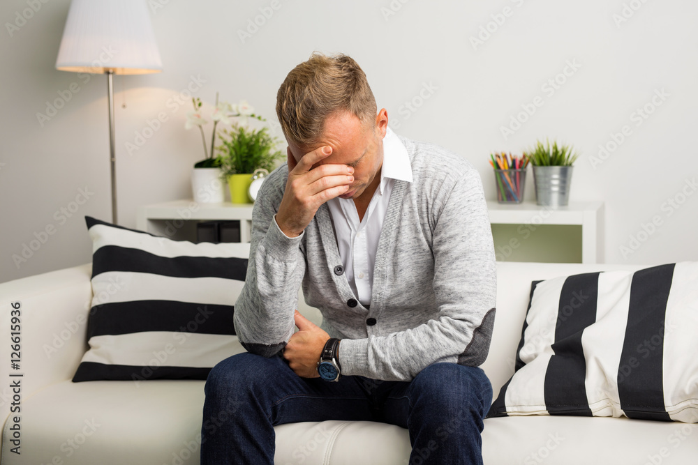 Depressed man sitting on the couch