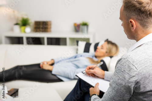 Woman lying on couch at doctors office photo