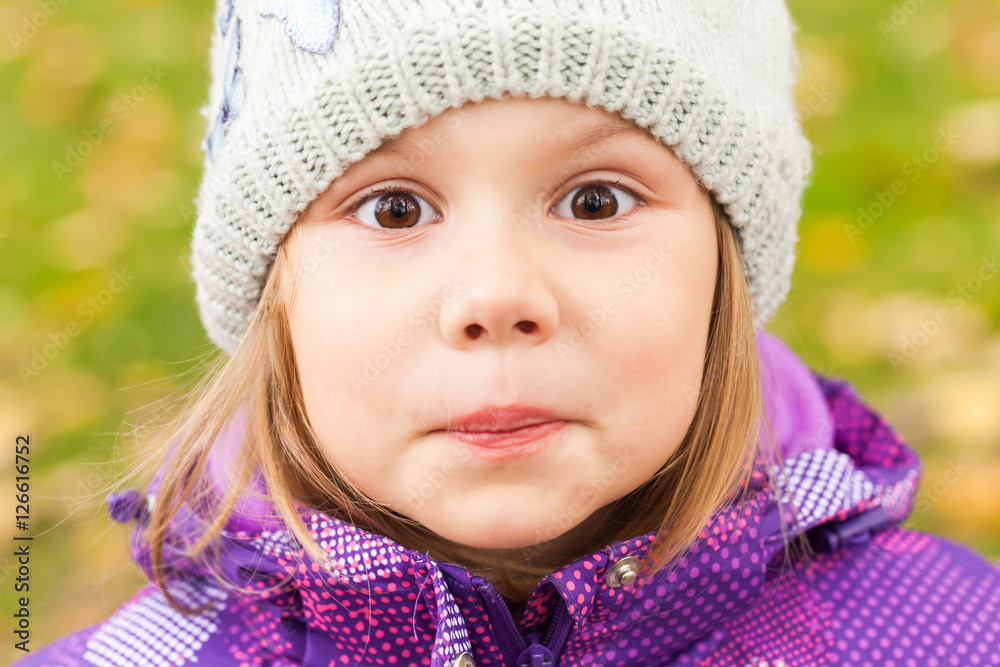Funny smiling Caucasian little girl, close up