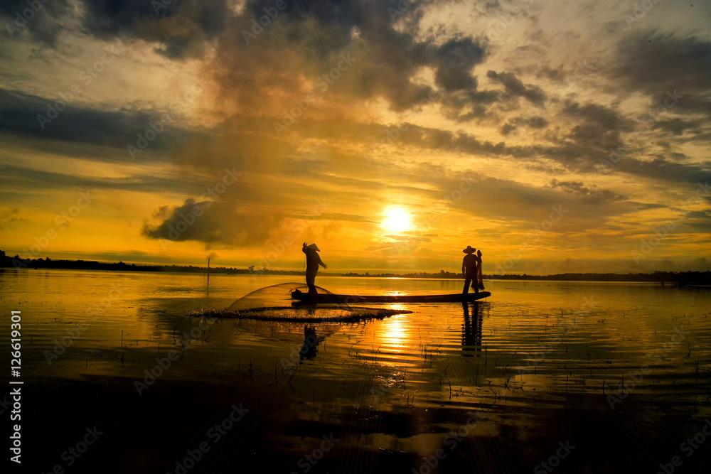 Fishermen out fishing with nets in the morning sunrise.