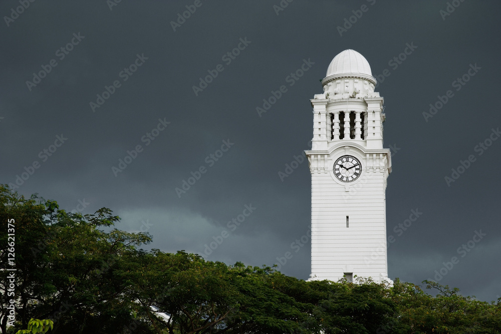 Clock tower against dark skies