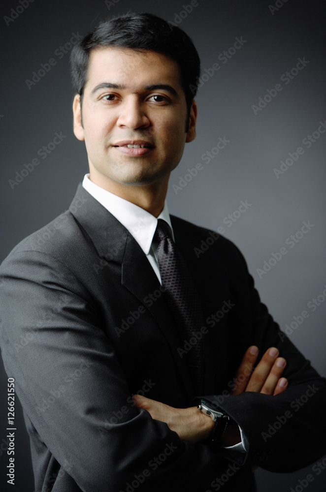 Businessman looking at camera, arms crossed, portrait Businessman looking at camera, arms crossed, portrait