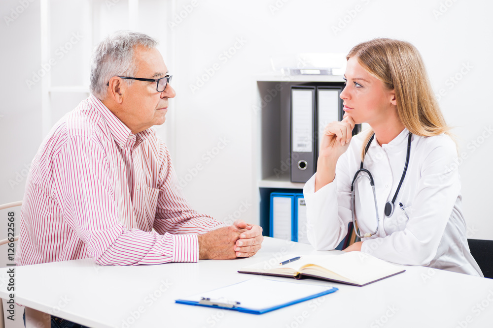 Patient is telling doctor about his health problems. Patient is telling doctor about his health problems.