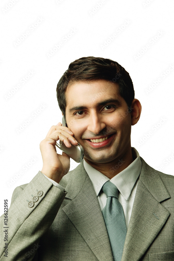 Businessman using mobile phone, facing camera Businessman using mobile phone, facing camera