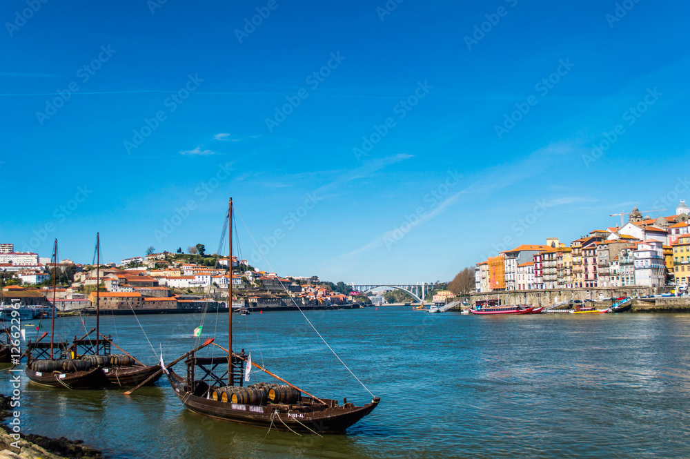 Old Porto cityscape skyline, traditional boats with wine barrels and Douro River in Porto, Portugal
