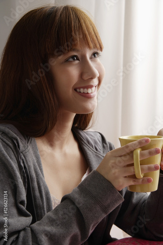 Asian girl holding coffee mug