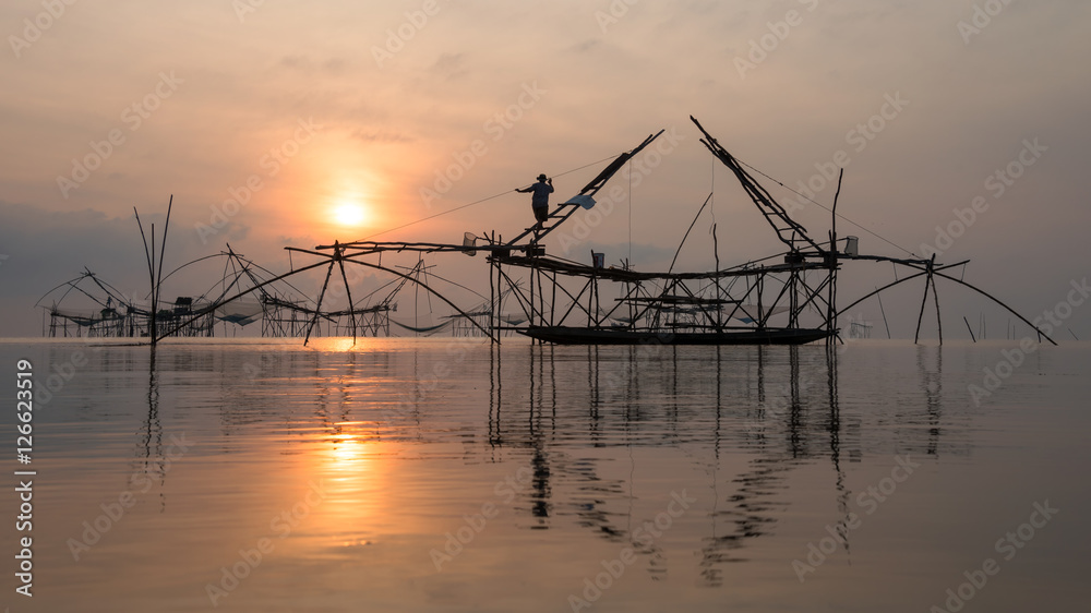 Fototapeta premium Fisherman with giant square dip net at Pakpra canal, Phatthalung, Thailand.