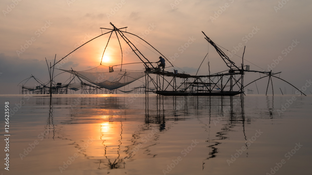 Fisherman with giant square dip net at Pakpra canal, Phatthalung, Thailand.