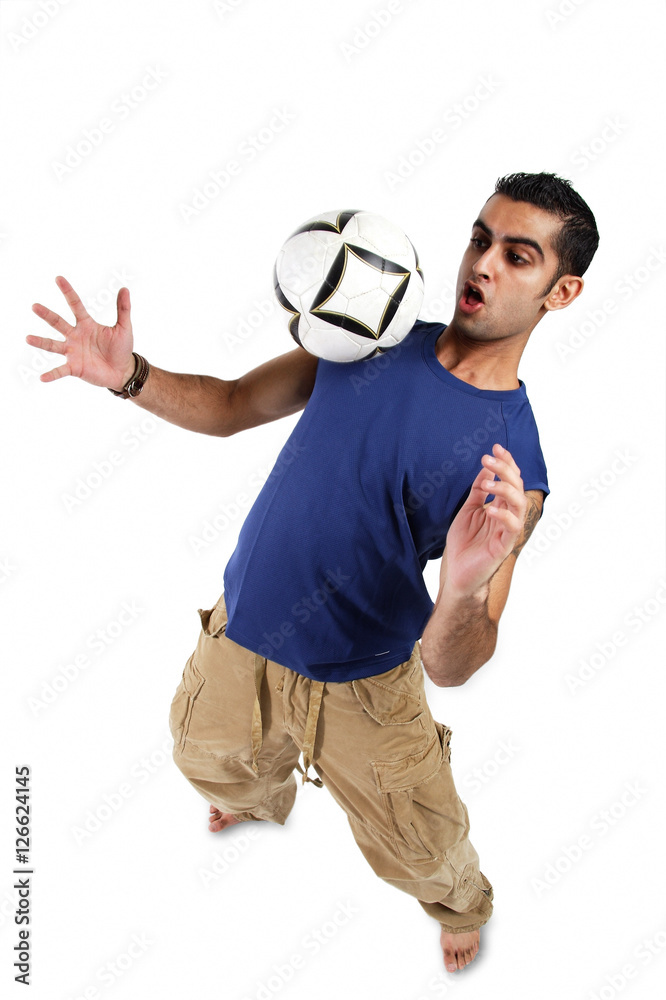 Young man bouncing soccer ball on his chest