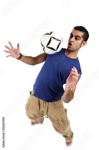 Young man bouncing soccer ball on his chest