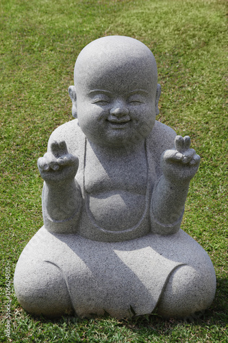 Stone statue of happy Buddha