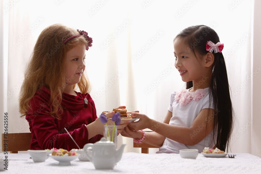 two young girls having a tea party two young girls having a tea party