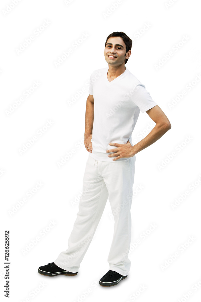 Young man looking at camera, hands on hips Young man looking at camera, hands on hips