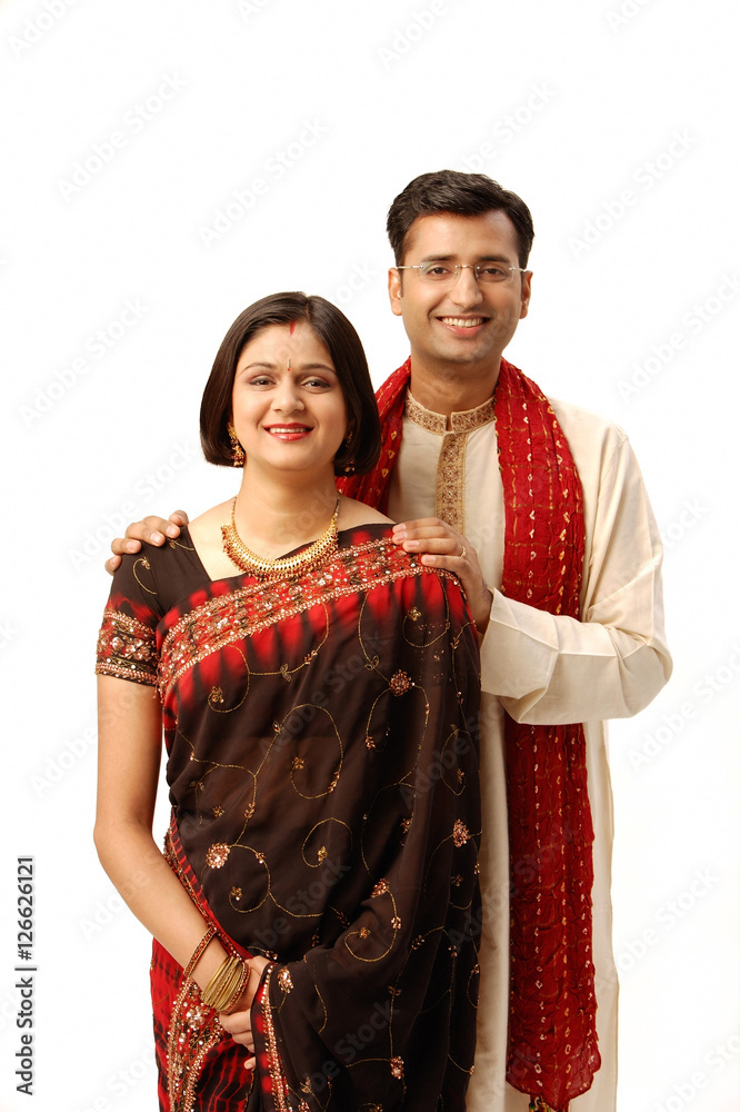 Indian couple in traditional clothing, looking at camera
