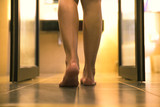 Young female legs walking towards to toilet