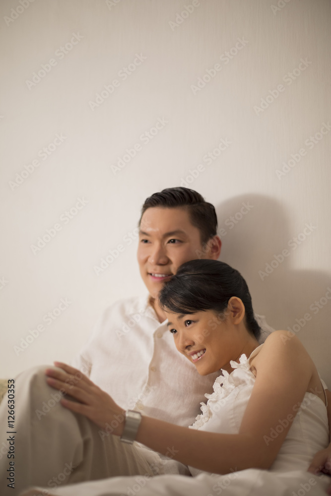 Singapore, Mid adult couple sitting on sofa Singapore, Mid adult couple sitting on sofa