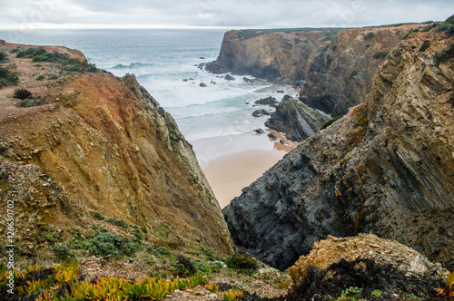 Cliffs near the Atlantic ocean coast in cloudy rainy day in Alentejo, Portugal