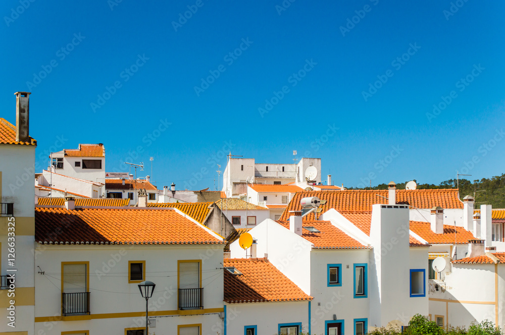 Odeceixe cityscape  - white houses with red roofs and blue sky in Odeceixe, Portugal