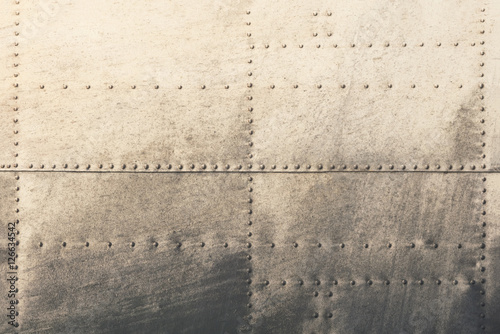Old metal silver surface of the aircraft fuselage with rivets