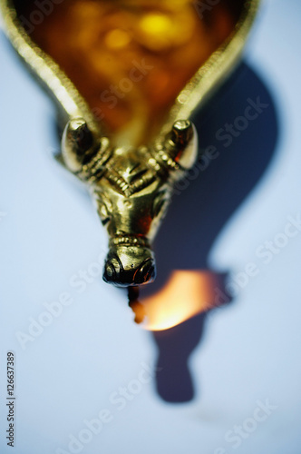 Still life of oil lamp with animal detailing