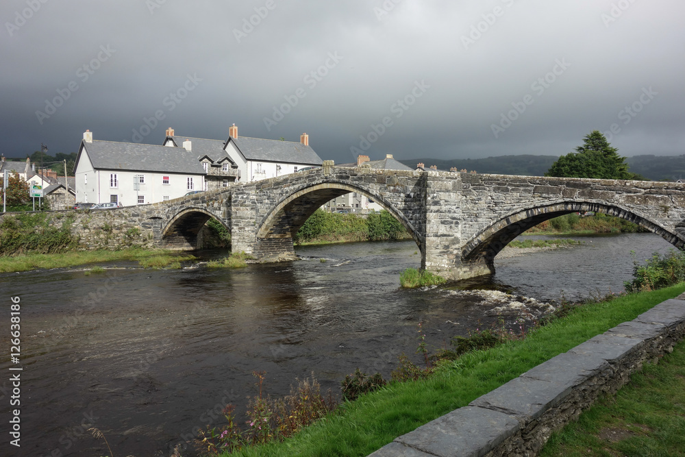 Y Bont Fawr - Llanrwst Bridge: stone bridge over the river Conwy in North Wales, United Kingdom in the dull and cloudy day, selective focus