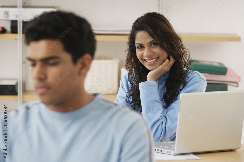 Fototapeta premium Young couple studying at desks