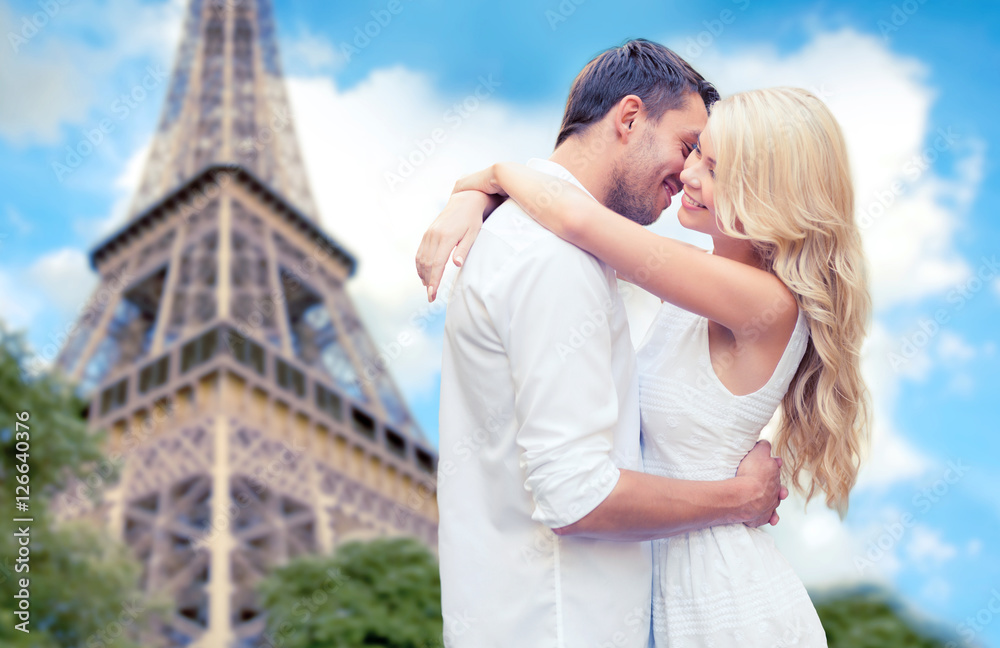 happy couple hugging over eiffel tower