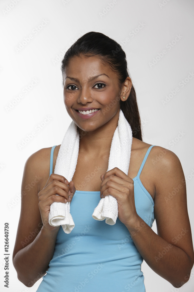 woman holding small towel around neck and smiling woman holding small towel around neck and smiling
