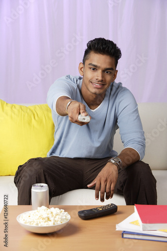 young man with television remote