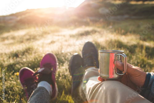 couple in mountains drinking hot coffee or tea