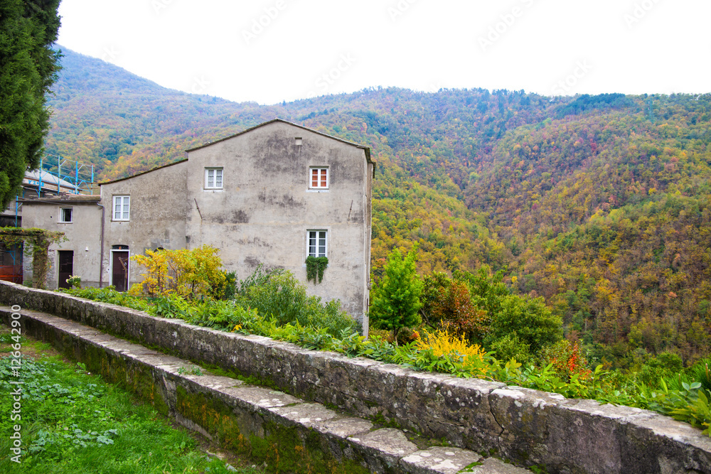 Old house in an autumn setting / Italy