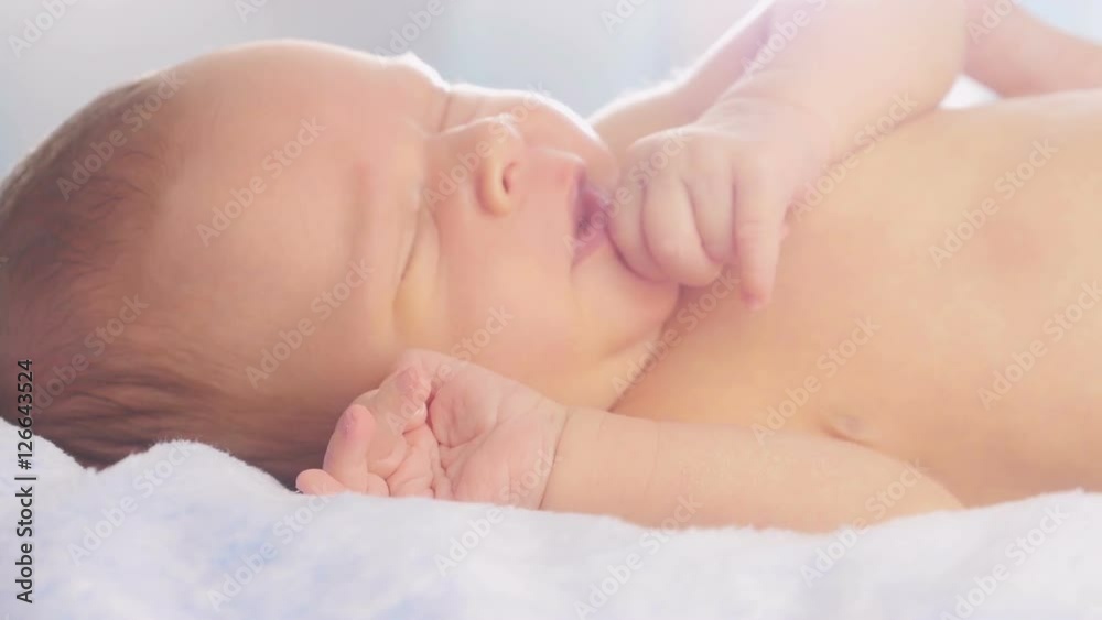 Mom stroking and kissing newborn baby.
Mom stroking and kissing newborn baby.
