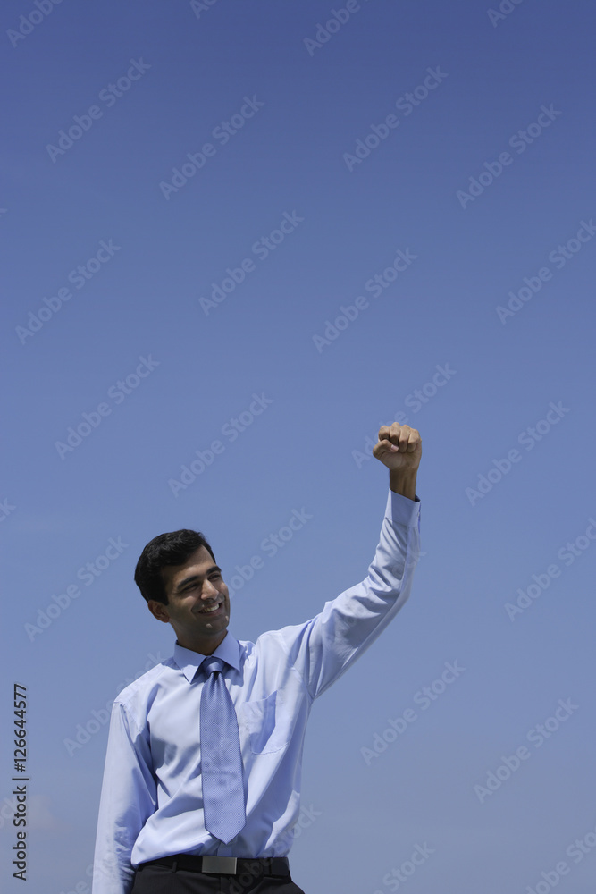 Indian businessman raising his fist. Indian businessman raising his fist.