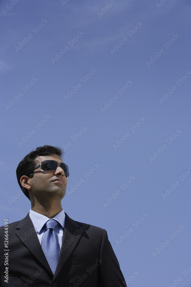 Indian businessman wearing sunglasses outside Indian businessman wearing sunglasses outside
