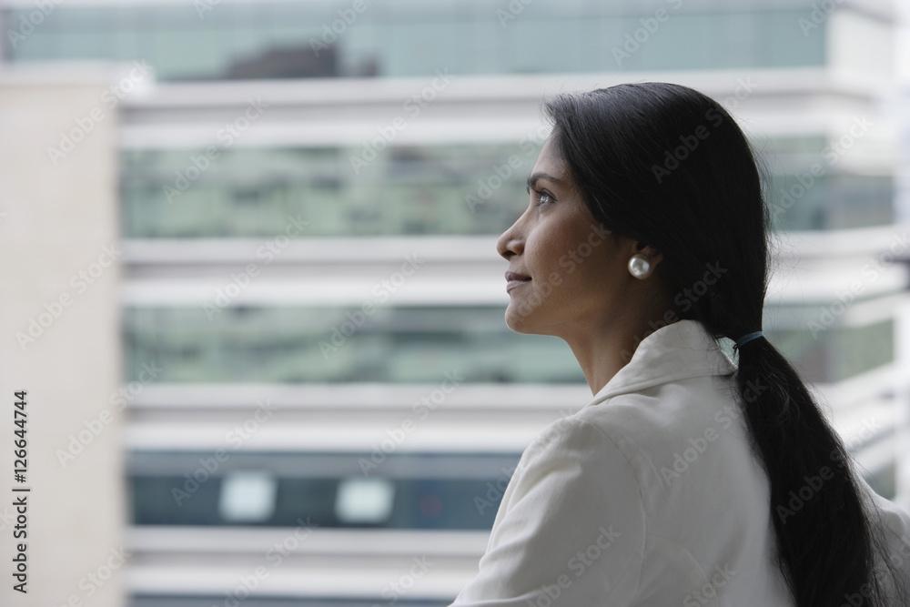 Profile of Indian woman looking at building. Profile of Indian woman looking at building.