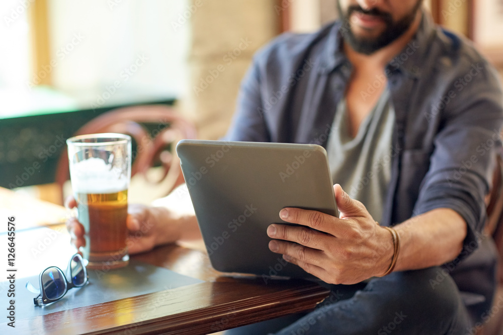 close up of man with tablet pc and beer at pub close up of man with tablet pc and beer at pub