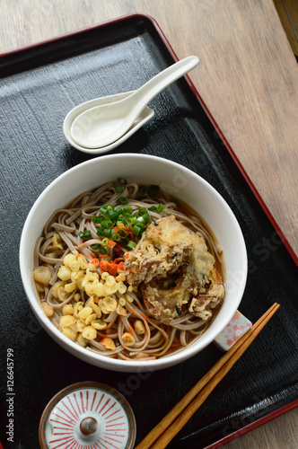 a bowl of soba noodle soup with deep fried tempura