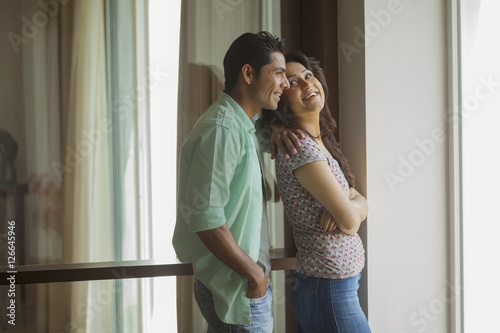 Canvas Print India, Man and woman standing side by side next to window