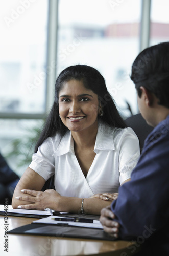 Indian woman smiling during meeting © Alexander